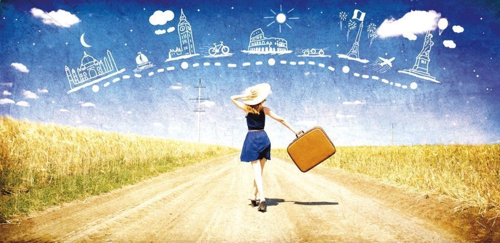 Lonely girl with suitcase at country road dreaming about travel.