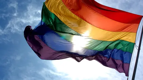 Rainbow_flag_and_blue_skies